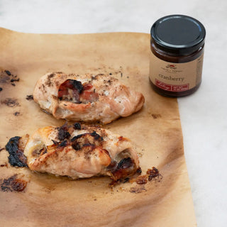 10 oz Cranberry Chutney jar by Finch & Fennel beside roasted chicken on parchment