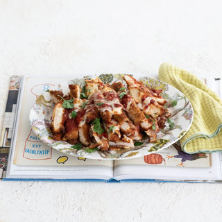 That's Amore Topper Seasoning plate of crispy chicken pieces with red tomato sauce, melted cheese, and parsley