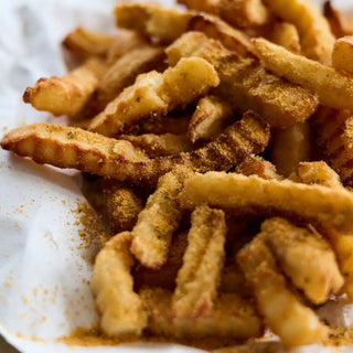 That's Amore Topper Seasoning on crispy fries with a golden-brown crust and spice dust.