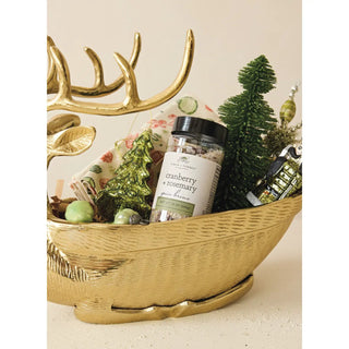 Cranberry + rosemary spice brine jar, clear glass with black lid, in a gold decorative holiday basket.