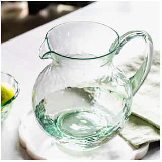 Green hammered acrylic pitcher with curved handle and wide spout
