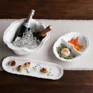 Three white beaded-edge melamine serving trays; bottles on ice, divided tray with carrots and greens, and an appetizer platter.