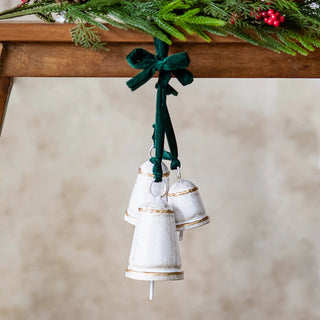 White and gold conical bell cluster on green velvet cords, hanging Christmas ornament.