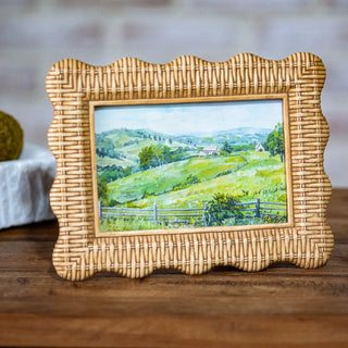 Natural weave landscape art in a tan wicker frame featuring a rural countryside scene