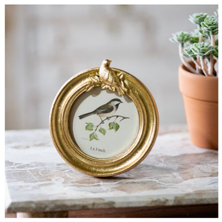 Round gold-tone photo frame with ornate bird accent, 3x3 inch