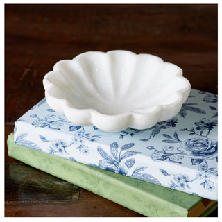 White marble scallop bowl, decorative bowl on blue floral books.