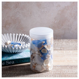 Clear jar of white and cobalt blue shells and sea glass with a white lid