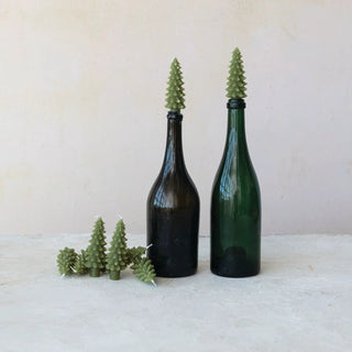 Candles: unscented green tree-shaped bottle-taper toppers on two glass bottles with small pine candles nearby