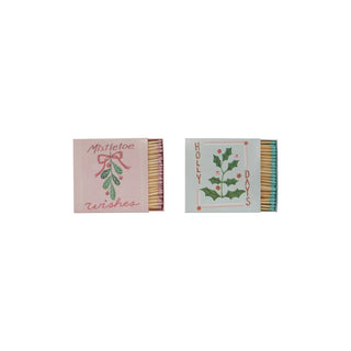 Set of 2: safety matches in embossed holiday matchboxes, pink mistletoe wishes and blue holly days with match heads.