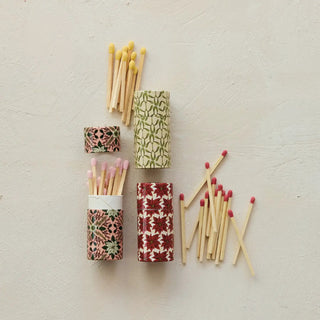 Safety matches in botanical-patterned tubes with yellow-tipped sticks and pink/red-tipped matches