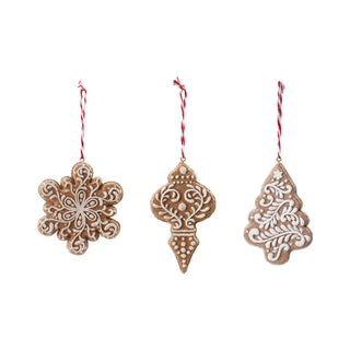 Resin gingerbread ornament trio in brown with white icing and glitter, hanging on red-and-white cords.