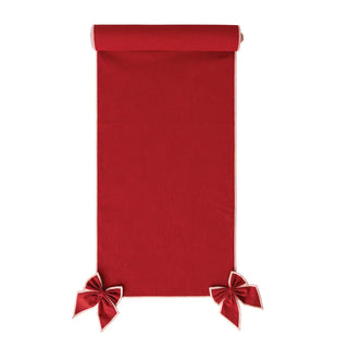 Cotton and linen red table runner with pink-stitched edge and detachable bows at corners.