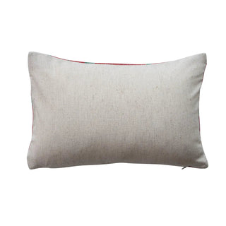 Cotton embroidered lumbar pillow with polka dot pattern, natural beige cover, visible zipper.