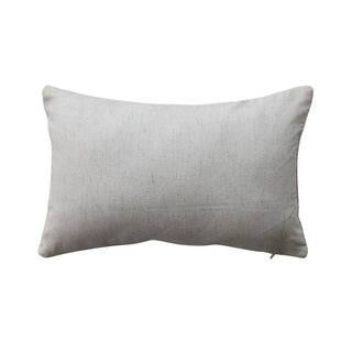 Natural beige cotton lumbar pillow with textured fabric; rectangular throw cushion.