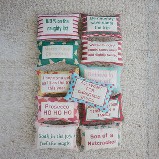 Decorative Christmas pillow set of 12 with embroidered holiday quotes in bright colors on striped and patterned fabric