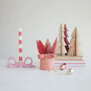 Pink ceramic bow-shaped taper candle holder with striped candle