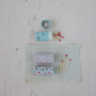 Safety matches in a light-blue holiday-pattern tube with red-tipped sticks