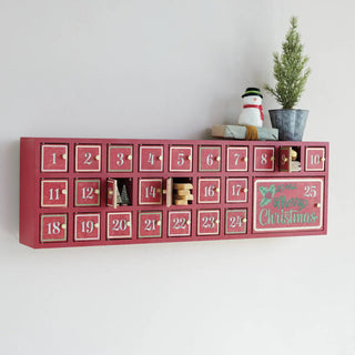 MDF Advent calendar with 25 red numbered doors; top features a snowman figurine and a potted plant.