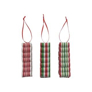 Ornaments: three clay striped ribbon candy ornaments with glitter on red ribbons, red/white and green stripes