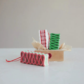Clay striped ribbon candy ornaments with glitter in red, white, and green