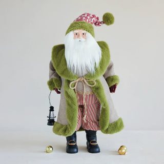 Santa figurine in fabric and faux fur, holding a lantern; green fur trim coat, red striped pants, black boots