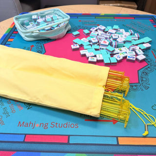 Lunaflor Mahjong Mat with turquoise tiles and a mint zipper pouch on a colorful mat