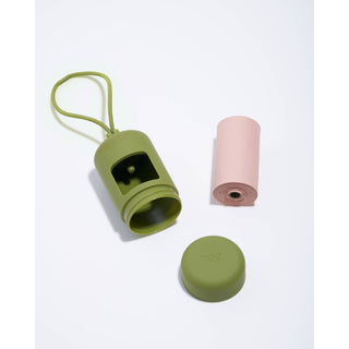 Poop bag dispenser for pets in olive-green with strap and pink bag roll