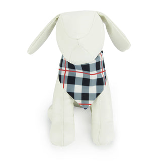 Dapper pet bandana in black and white plaid on a white plush dog
