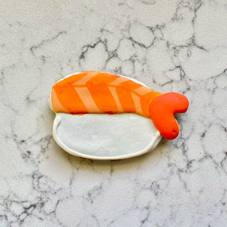 Lunch Menu dog treat cookie with orange striped icing on a white base