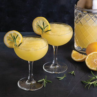 Natural Lemon Burst Wine Slushy Mix two yellow cocktails with lemon slices and rosemary garnish