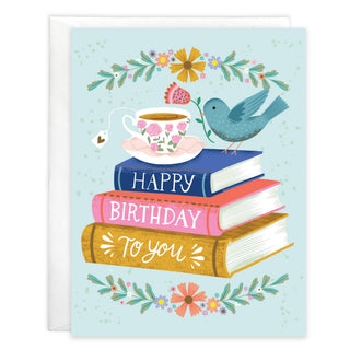 Birthday greeting card with envelope featuring Books & Bird: blue bird perched on a colorful stack of books with a teacup