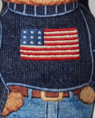 Ruff Lauren Teddy Dog plush squeaker toy shown on a navy knit sweater with an American flag patch