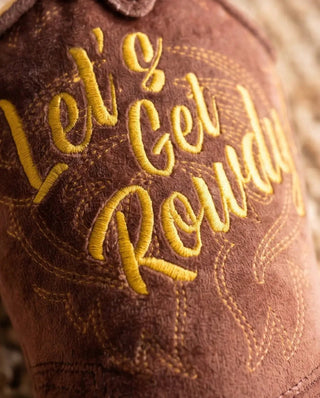 Brown western cowboy boot dog toy with yellow embroidered lettering on a suede-like surface.