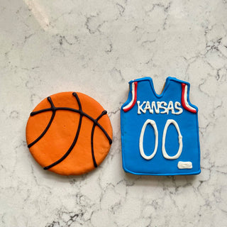 Sports ball buffet cookies: orange basketball and blue Kansas jersey cookies.
