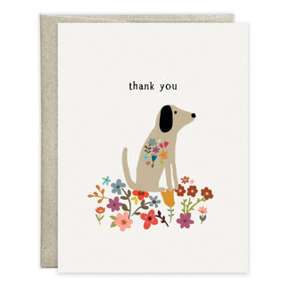 Thank you greeting card with envelope behind; features a sweet tan dog among colorful flowers and top text thank you.