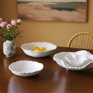 White mini wavy bowl with beaded edge, part of a dining set on a wooden table