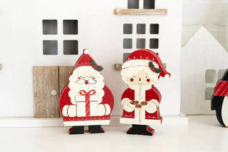 Chunky wooden Santa ornaments (2) in red and white with black shoes, displayed side by side.
