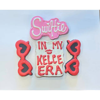 Swiftie Era Dapper cookies, 4-piece set with pink Swiftie, white center with red text, and red ear-shaped cookies.