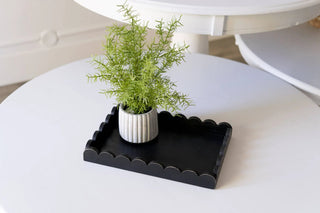 Wood scallop tray, black, 13x9x2, with a ribbed white vase and green plant.