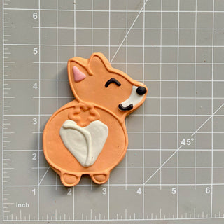 Dapper corgi-shaped dog treat cookie in peach with a white heart belly