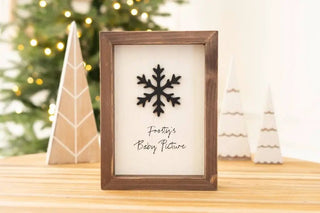 Wood frame sign 6x8 in featuring a black snowflake on a white panel with Frosty’s Baby Picture text