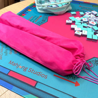 Lunaflor Mahjong Mat on a blue game mat with pink sections and scattered turquoise tiles.