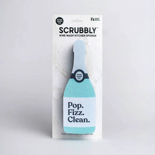 Scrubbly kitchen sponge shaped like a champagne bottle in blue and turquoise with a Pop. Fizz. Clean. label.