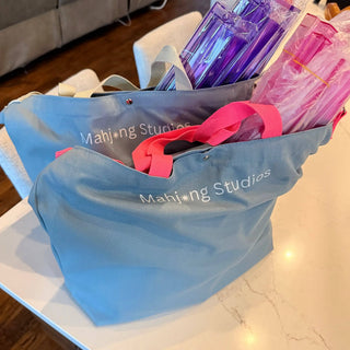 Rose Dragon American Mahjong tile set, 166 tiles, in a blue tote bag with pink handles.