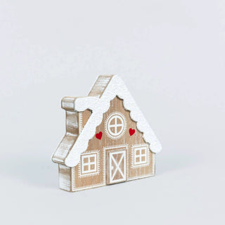Wooden cabin-shaped Christmas decor, 6x5, snow-dusted roof with white detailing and decorative windows.