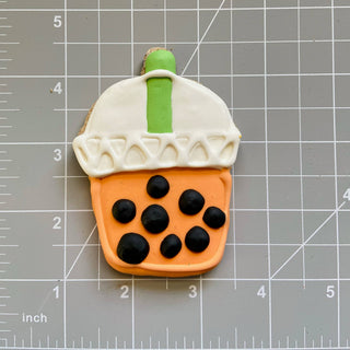 Lunch Menu Dapper dog treat cookie shaped like bubble-tea cup with white lid, orange cup base and black pearls