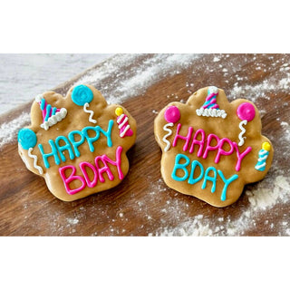 PB BDAY Paw dog treats, two decorated cookies with blue and pink icing