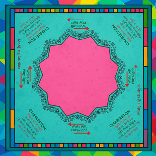 Lunaflor Mahjong Mat laid on a teal surface with pink center and ornate black border, framed by a colorful tile border.