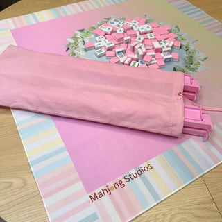 Pink fabric Mahjong rack storage bag for 17.5–20 inch racks; scattered pink and white Mahjong tiles on a floral mat.