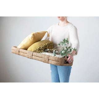 Hand-woven Bankuan tray with handles; natural wicker, yellow cushions, and greenery